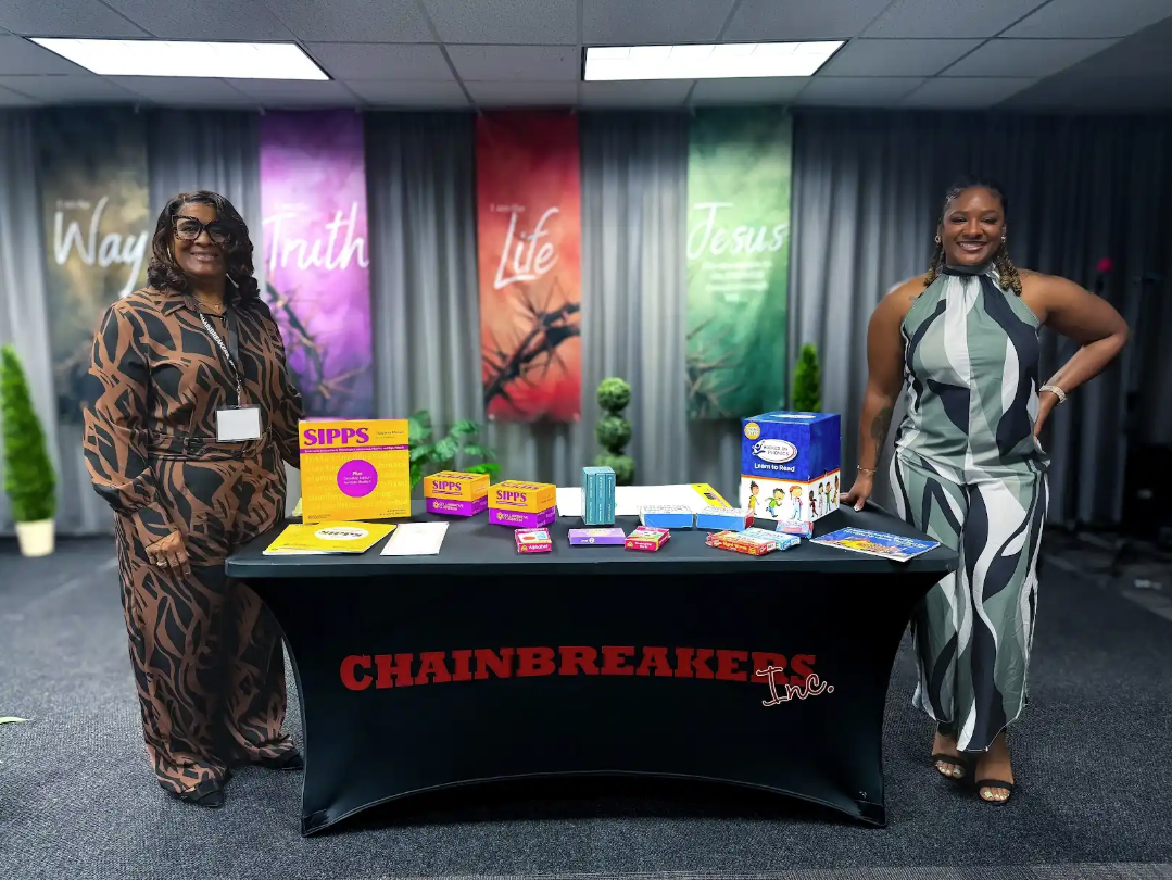 Women beside educational materials