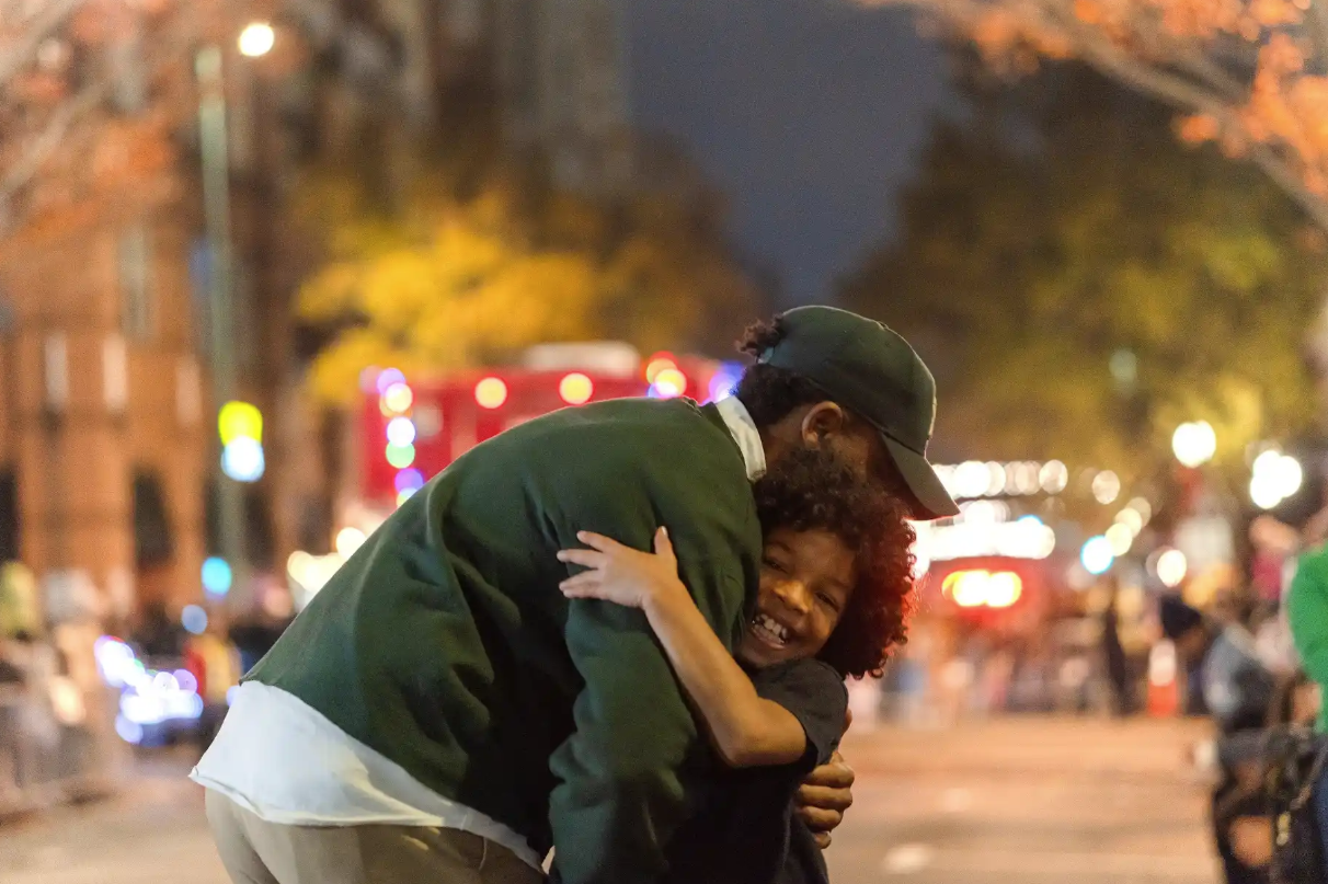 Man hugging smiling child